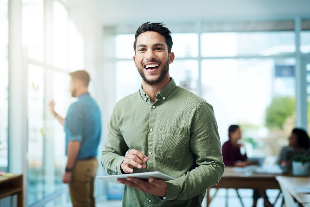 Man smiling with ipad in his hand