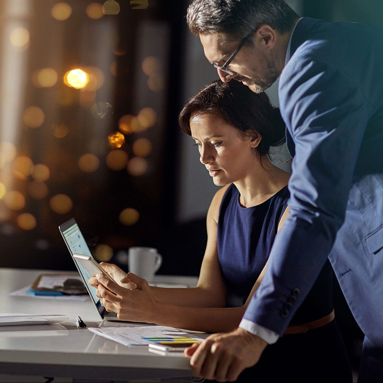 man-and-woman-leaning-over-desk